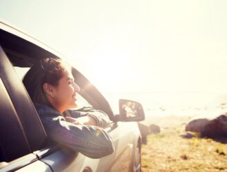 Happy woman inside a car