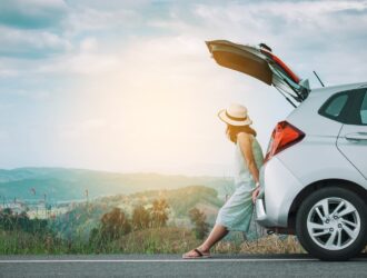 woman sitting on the back of a car