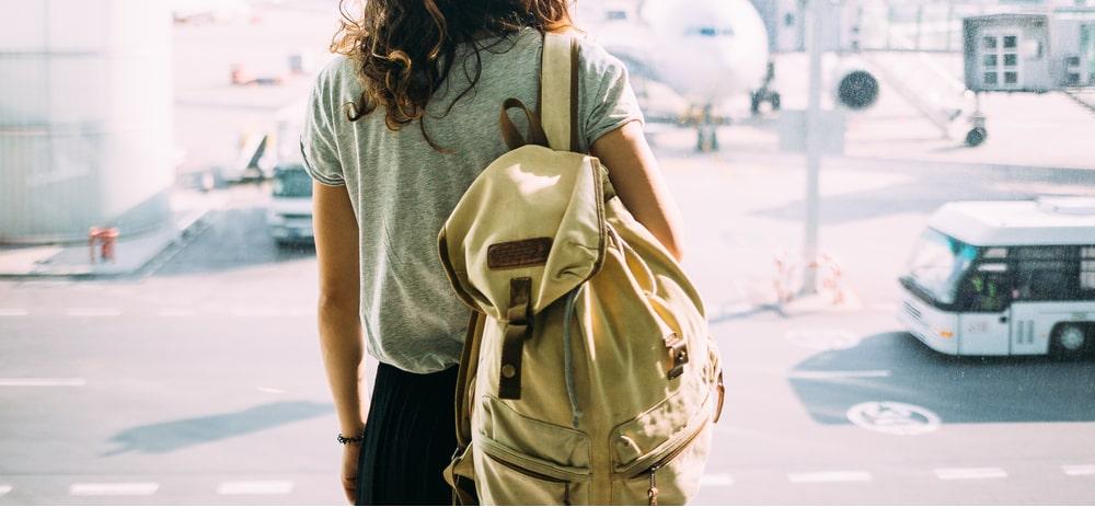 young woman with a backpack in an airport
