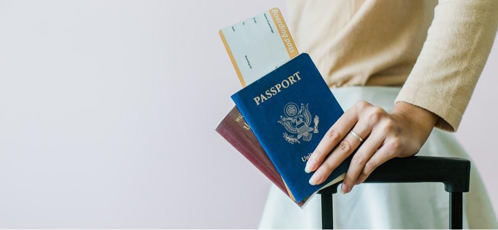 woman holding a boarding pass and passport