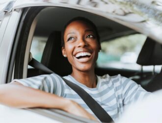 mulher sorrindo dentro de um carro