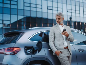 A business man with your eletric car in Europe