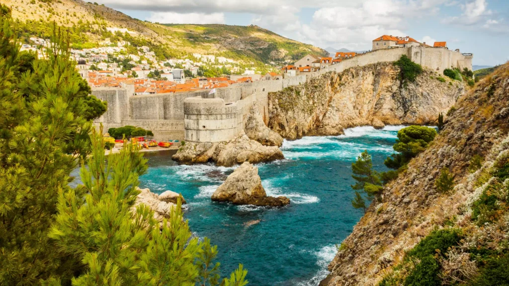 Aerial view of Dubrovnik, Croatia, with the mountains and the ocean.