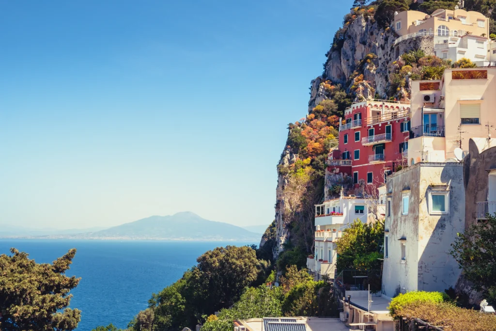 Capri townhouses with a view of Mount Vesuvius in the distance.